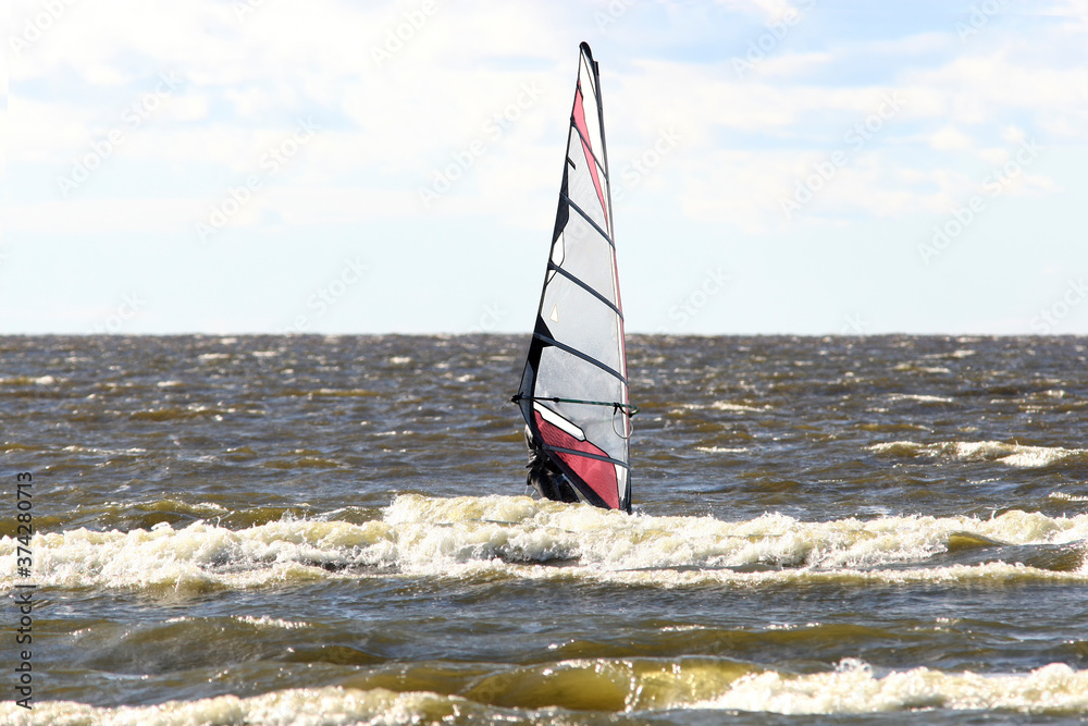 Fototapeta premium Windsurfing sport at sea waves