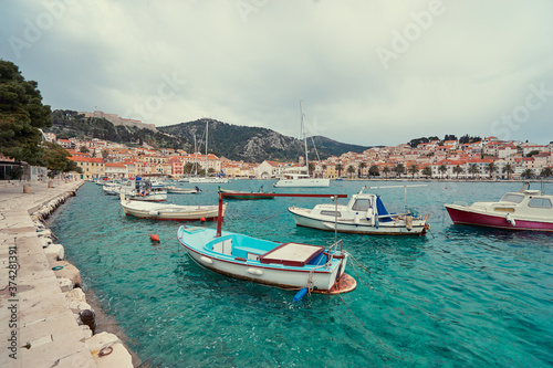 Fototapeta Naklejka Na Ścianę i Meble -  Fishing boats in harbor. Hvar Old Town Promenade. Sea coast in Dalmatia, Croatia.