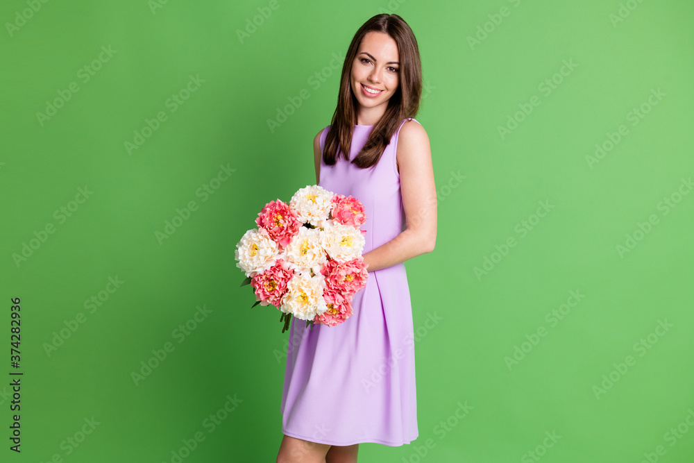Portrait of her she nice attractive pretty charming elegant cheerful cheery girl holding in hands fresh bunch flowers prom date festal occasion isolated over green color background Portrait of her she nice attractive pretty charming elegant cheerful cheery girl holding in hands fresh bunch flowers prom date festal occasion isolated over green color background