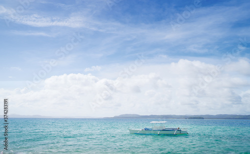 Fototapeta Naklejka Na Ścianę i Meble -  Beautiful landscape with tropical white sand beach with fishing boats. Siargao Island, Philippines.