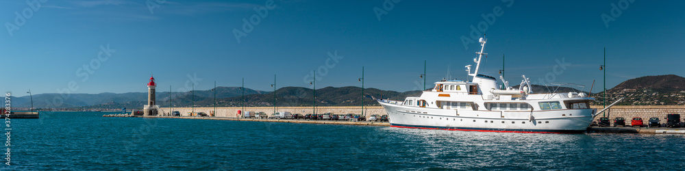 panorama of a yacht moored at a quay along a  jetty in Saint Tropez