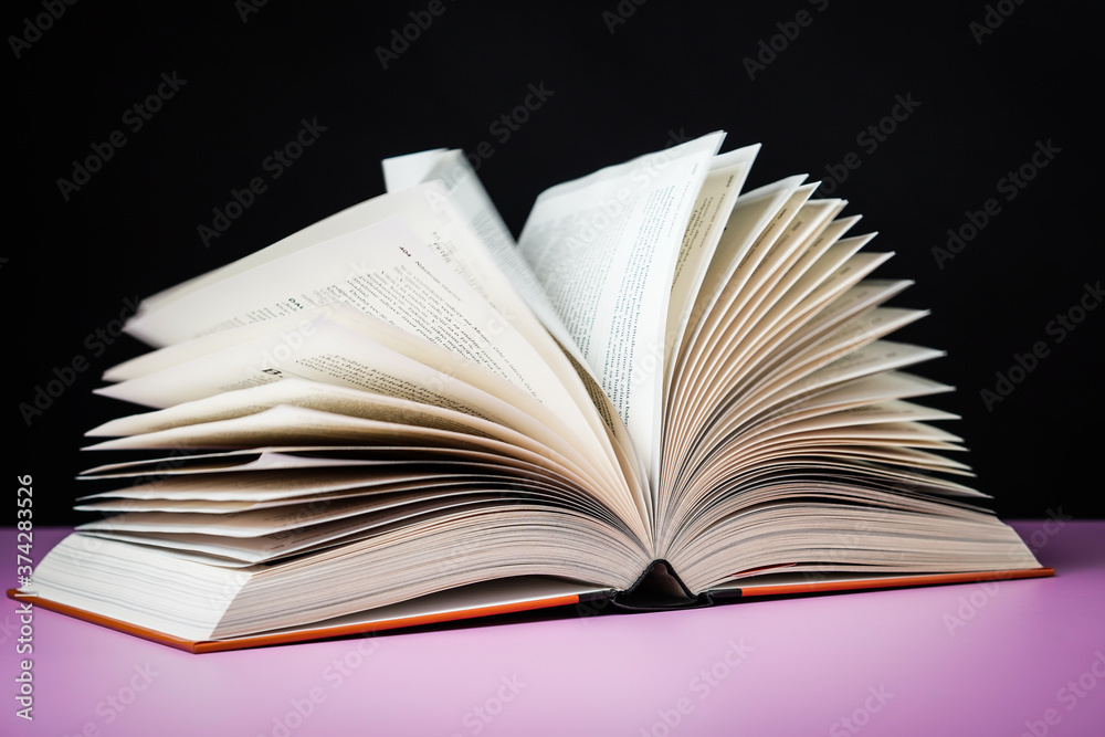 Fototapeta premium Open book on the table. It is time for education and therefore you need to go back to school.
