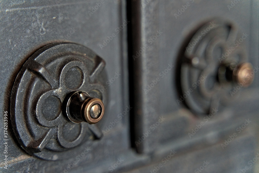 Detail from cast iron fireplace, Iron handle. Detail from cast iron fireplace, Iron handle.