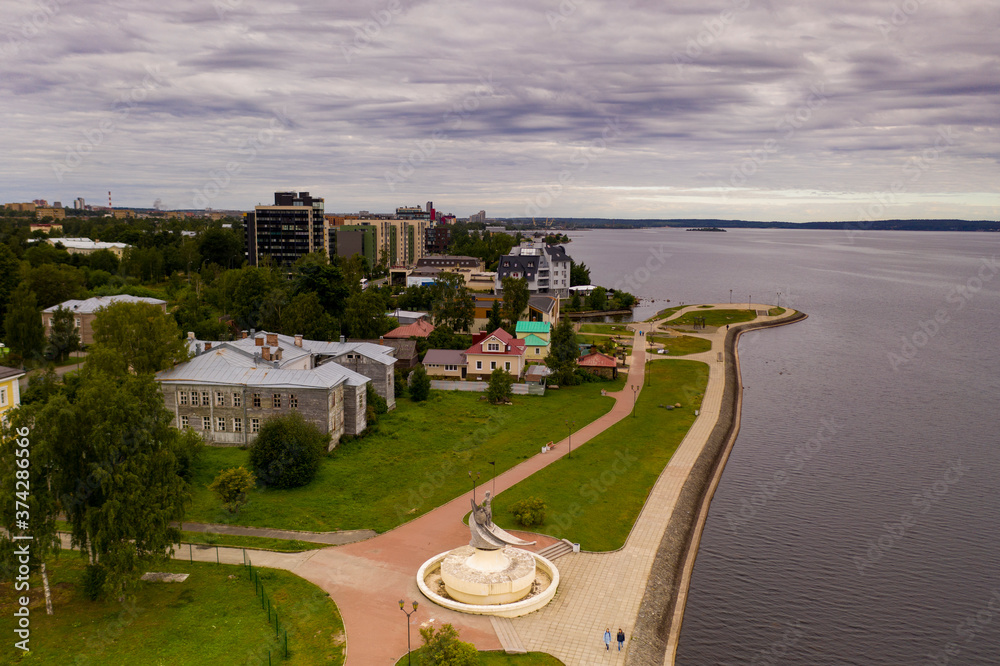 panoramic view of the city embankment near the lake in the morning filmed from a drone