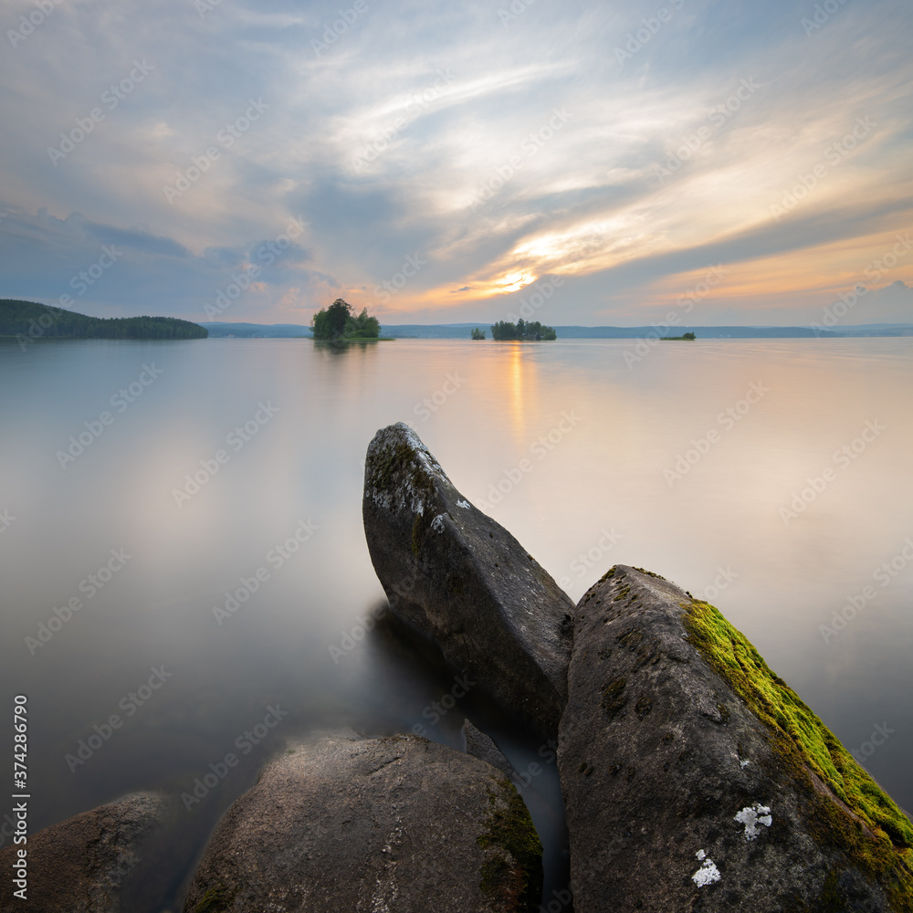 Landscape captured at sunset with textured foreground and long exposure Landscape captured at sunset with textured foreground and long exposure