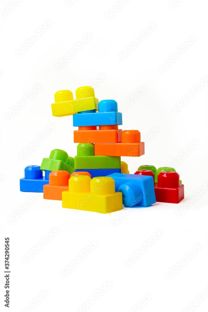 Scattered bright multi-colored children's designer on a white background. Childhood. Useful and interesting games. Scattered bright multi-colored children's designer on a white background. Childhood. Useful and interesting games.