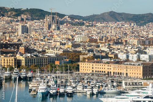 Cityscape of Barcelona with the port. Aerial view from the cable car that connects La Barceloneta beach to Montjuic hill. Catalonia, Spain