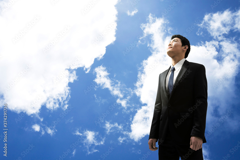 businessman standing with blue sky businessman standing with blue sky