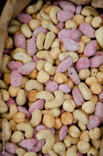 Obraz na płótnie Colored nuts are covered with glaze. Lots of delicious nuts background. w salonie