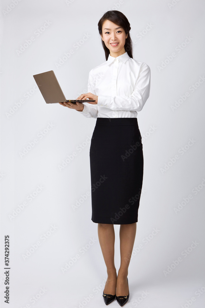 businesswoman holding a laptop on white background businesswoman holding a laptop on white background