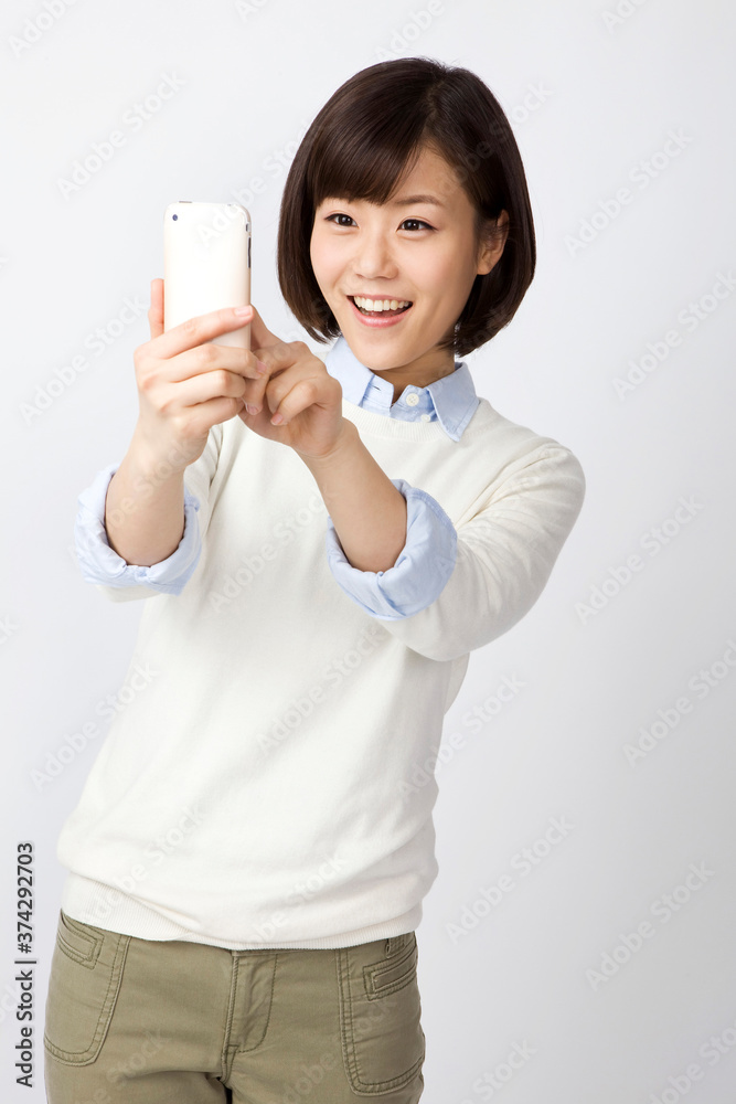 young woman holding a mobile phone young woman holding a mobile phone