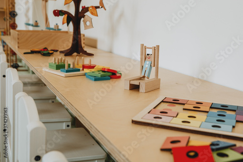 The wooden desk with wooden montessori toys on it in the montessori kindergarten photo