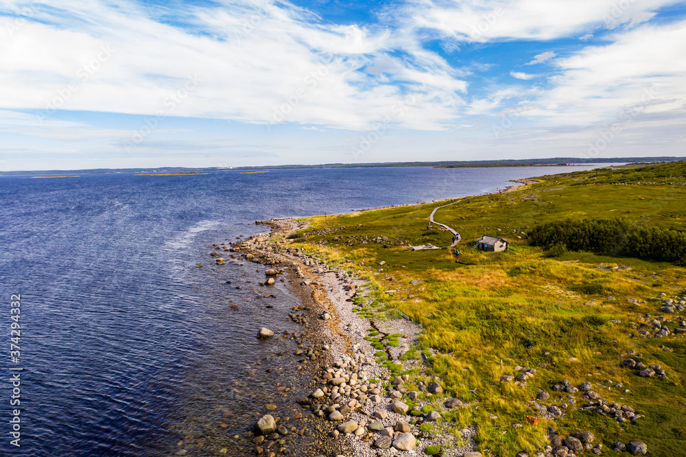 Obraz premium a panoramic view of an uninhabited island with an old church and ancient stone labyrinths filmed from a drone