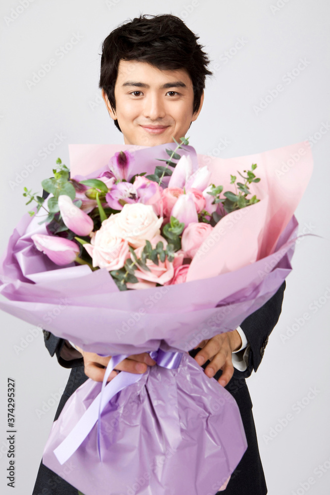 businessman holding a bouquet of flowers businessman holding a bouquet of flowers