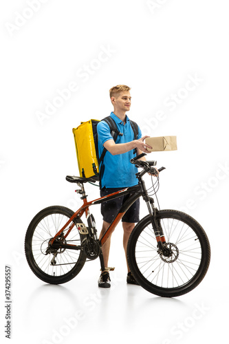 Giving order. Deliveryman with bicycle isolated on white studio background. Contacless service during quarantine. Man delivers food during isolation. Safety. Professional occupation. Copyspace for ad.