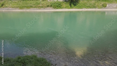 Small turquoise Restello lake and medieval  San Floriano tower ruins on the Alemagna road near Vittorio Veneto, Italy photo