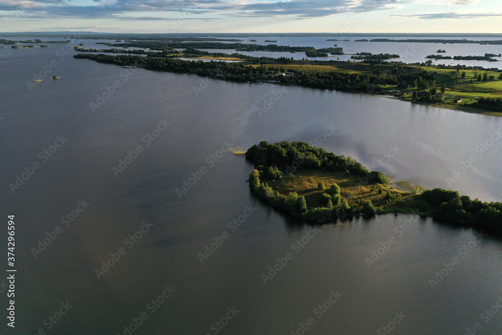 panoramic view of the lake with many islands on one of them there is an ancient temple made of wood at sunset filmed from a drone panoramic view of the lake with many islands on one of them there is an ancient temple made of wood at sunset filmed from a drone