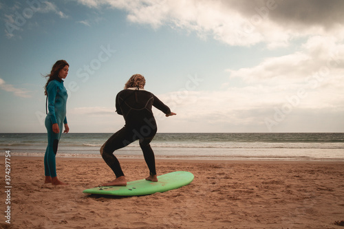 Photography Surfer girl taking a surf lesson and going to the beach