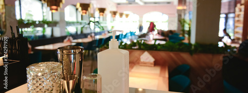 Hand sanitizer bottle on table in local restaurant for people to kill viruses. Coronavirus covid-19 pandemic.