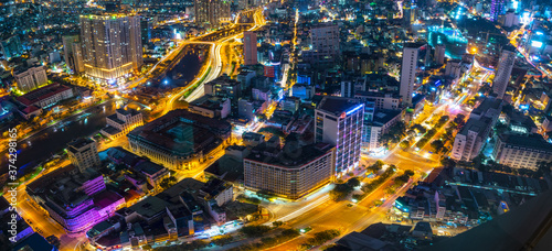 Night cityscape from above with lightstreet riverside create shimmering nocturnal beauty city developing dynamically in Ho Chi Minh City, Vietnam © huythoai