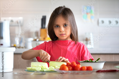 Little girl preparing healthy food - salad