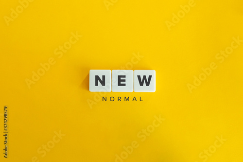 New Normal Buzzword and Banner. Block letters on bright yellow orange background. Minimal aesthetics. photo
