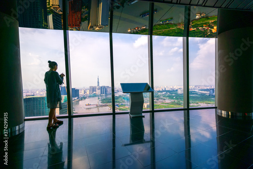 Tourists visit on top of the sky deck panoramic view point in downtown Ho Chi Minh City, Vietnam