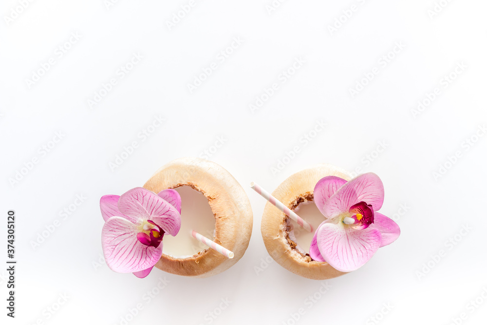 Raw coconut water or milk with straw, above view