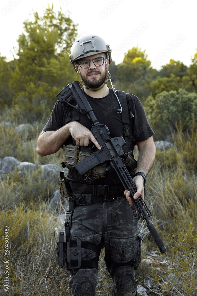 The Airsoft soldier is playing on the Mountain The Airsoft soldier is playing on the Mountain