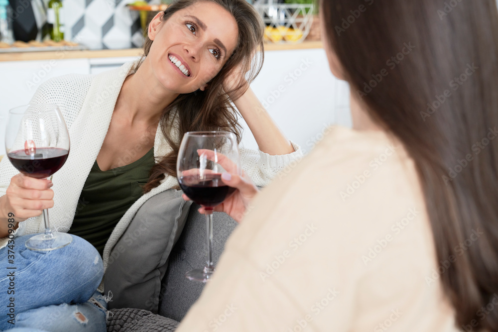 Friends spending time talking and drinking wine Friends spending time talking and drinking wine