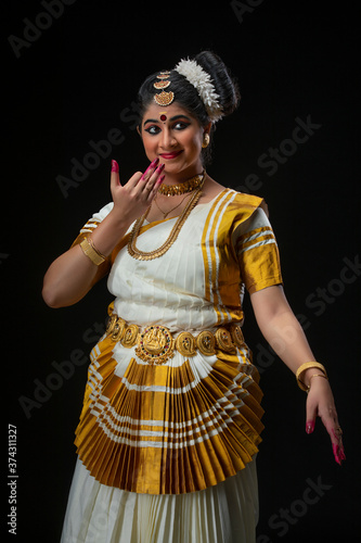 Mohiniattam artist perming a melodious song in her act
 photo