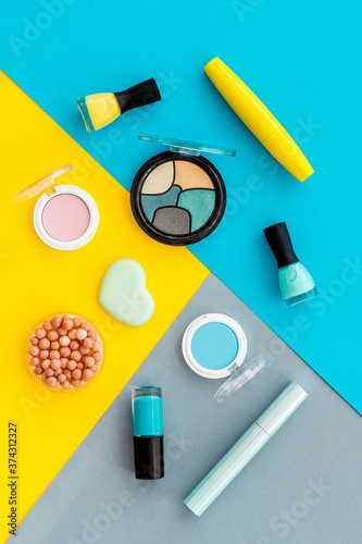 Set of decorative makeup cosmetics on colorful background, top view