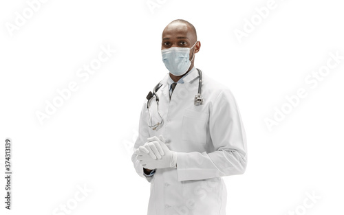 Face mask and gloves. African-american doctor on white background, professional occupation. Daily hard work for health and lives saving. Half-length portrait. Medicine, healthcare, profession concept.