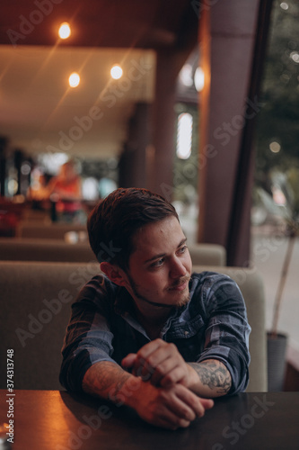 young man sitting in cafe