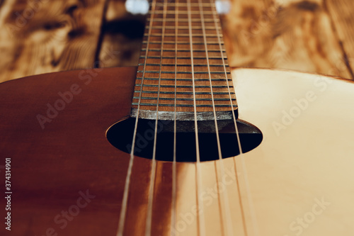 Wooden acoustic guitar body and fingerboard close up