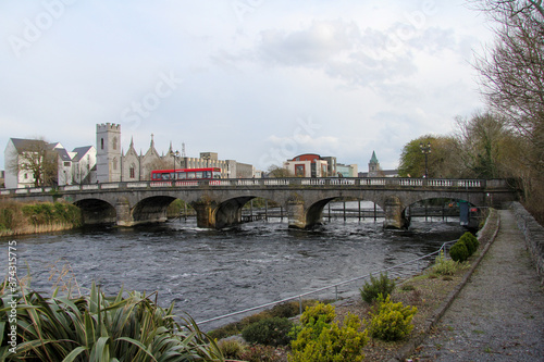 Stone bridge in Galway with the river flowing below and some buildings in the background