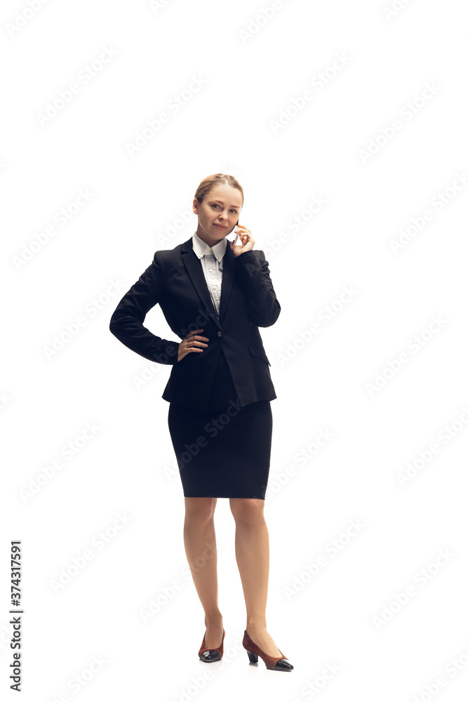 Talking phone. Young woman, accountant, finance analyst or booker in office suit isolated on white studio background. Caucasian woman, office worker. Finance, economy, professional occupation. Talking phone. Young woman, accountant, finance analyst or booker in office suit isolated on white studio background. Caucasian woman, office worker. Finance, economy, professional occupation.