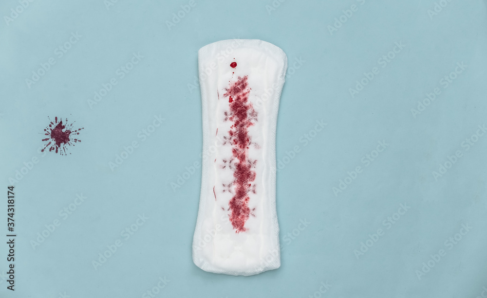 Menstruation theme. Female panty liners with blood on a blue background