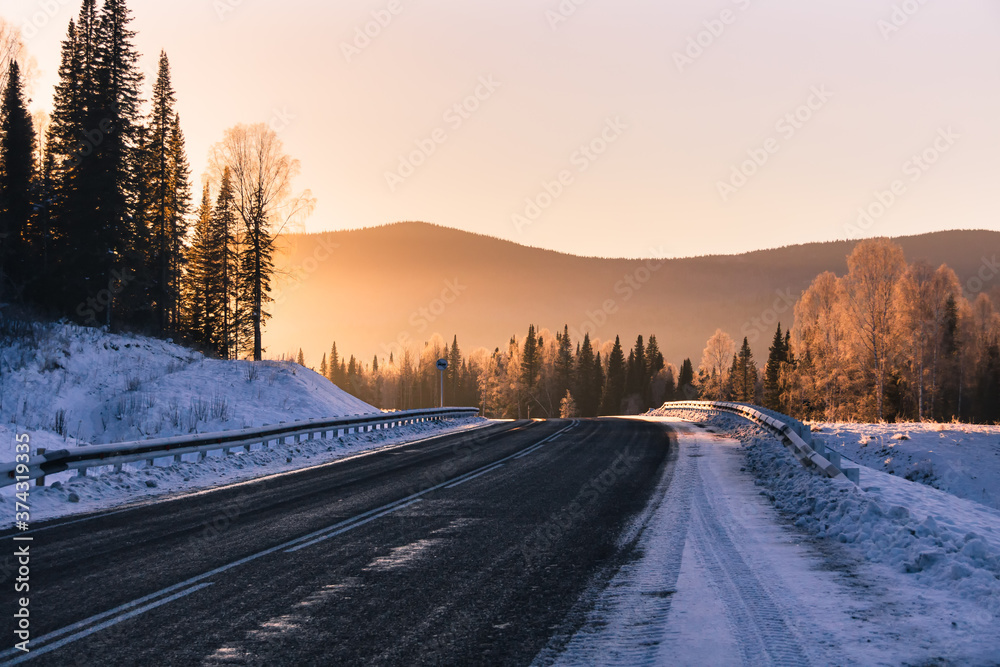 The road in the winter mountains in the background at sunrise
The road in the winter mountains in the background at sunrise