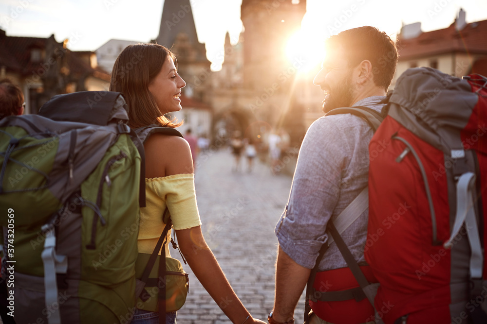 Obraz premium Couple in love walking in the streets of Prague at sunset.Travel, tourism and people concept.