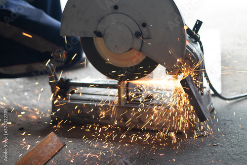 Worker,welding in a car factory with sparks, manufacturing, industry photo