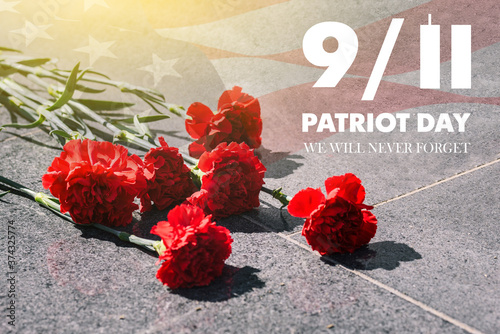 Carnations on the memorial with the American flag. Patriots ' day. September 11. We will never forget