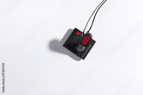 Retro joystick on white background with a shadow. Retro gaming. Top view