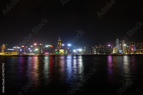 City landscape. Victoria Harbor and Hong Kong skyscrapers at night.