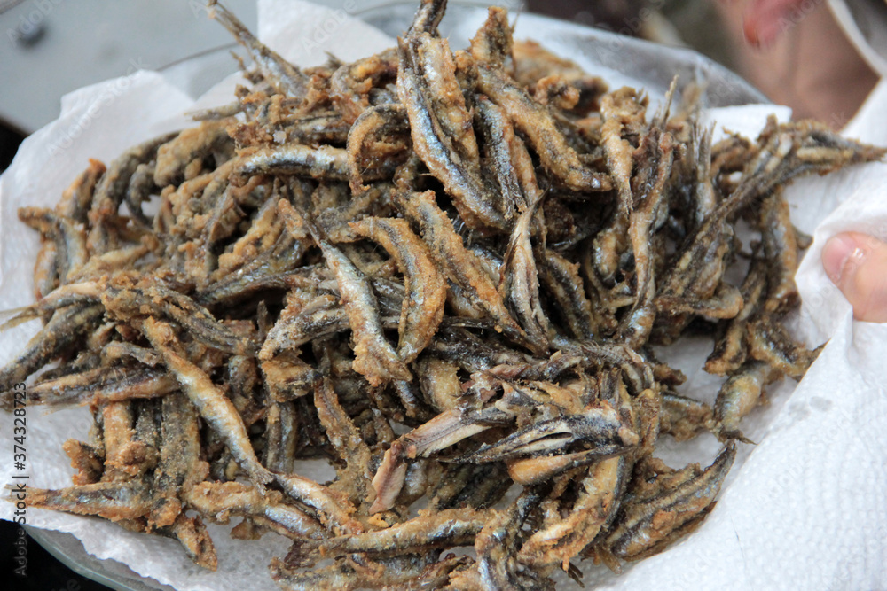 Anchovies are fried in vegetable oil in a pan. Anchovies are fried in vegetable oil in a pan.