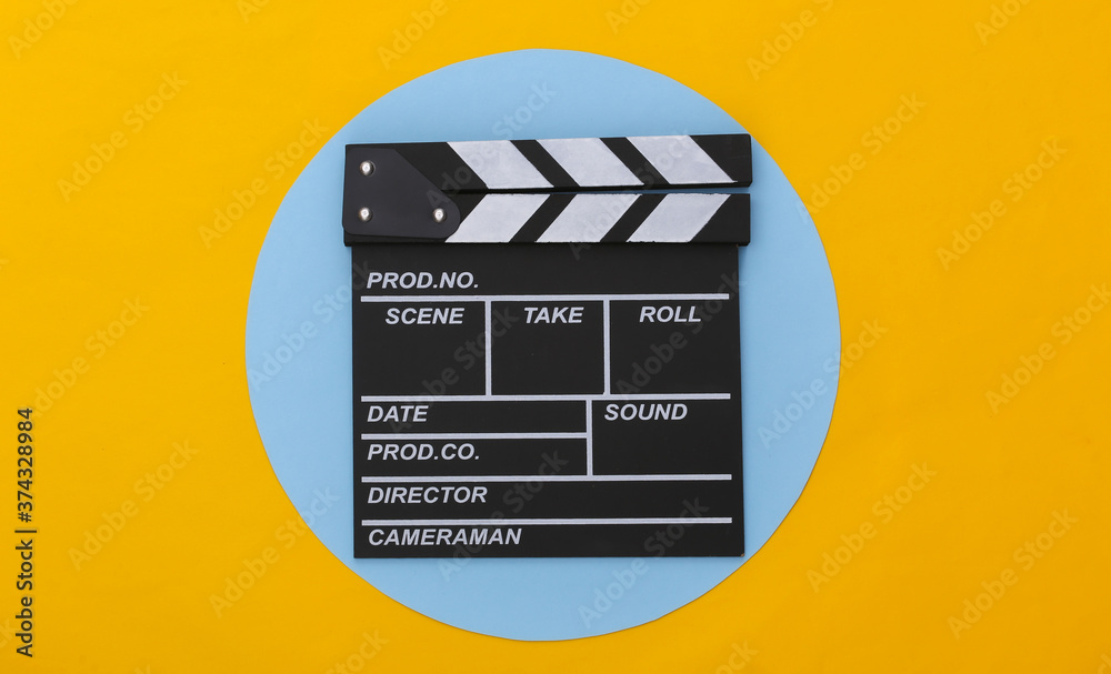 Movie clapper board on yellow blue background. Filmmaking, Movie production, Entertainment industry. Top view