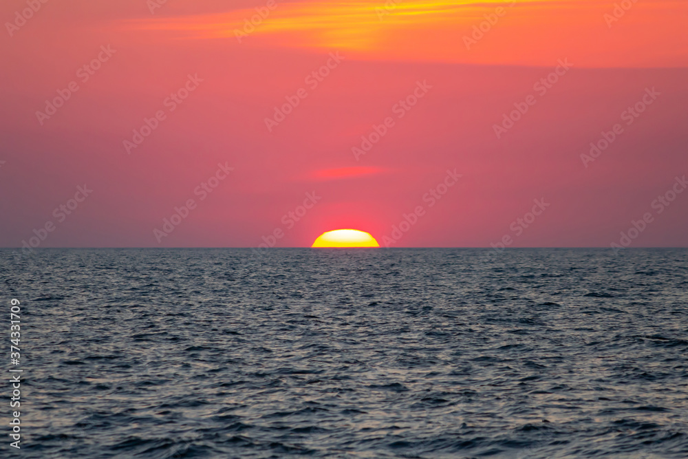 scarlet sunset over the sea, the sun set over the horizon