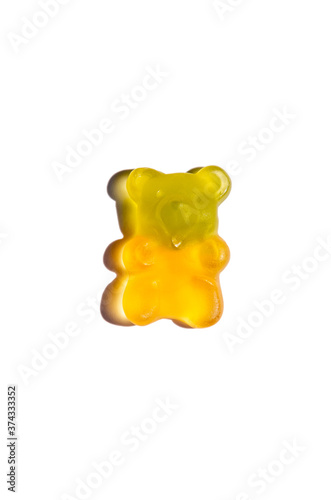 Sweet candy jelly bear cub of yellow-green color isolated on white background