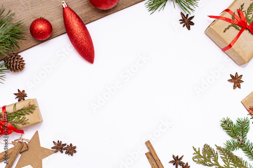 Gifts, Christmas tree branches and cones lie on a white background. Flat lay