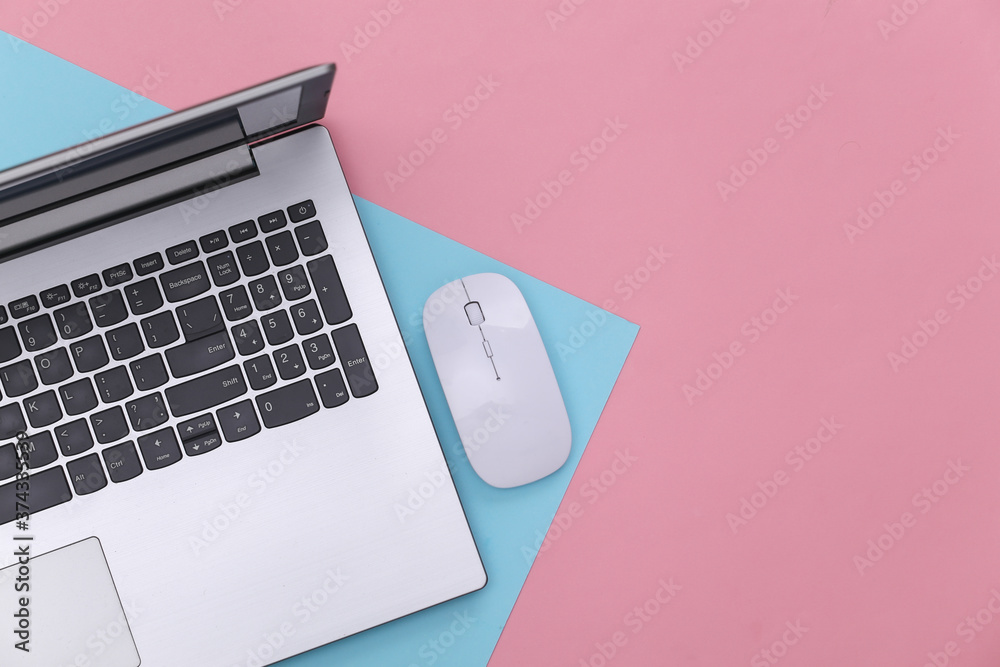 Laptop with pc mouse on pink blue background. Online workspace. Remote work. Studio shot. Color 2020. Top view. Flat lay Laptop with pc mouse on pink blue background. Online workspace. Remote work. Studio shot. Color 2020. Top view. Flat lay